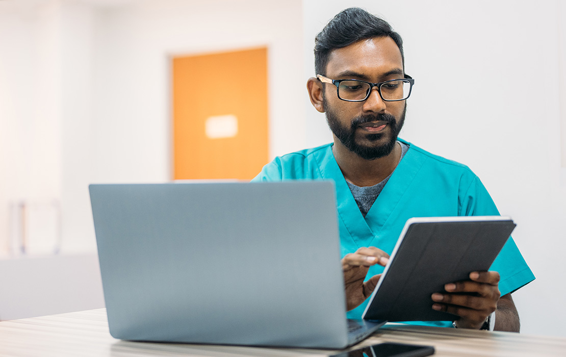 PostDoc student on tablet and computer