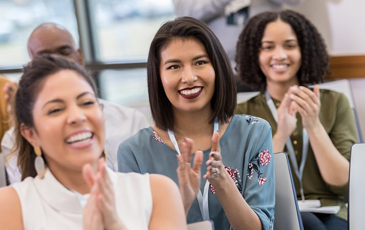 Audience smiling and clapping
