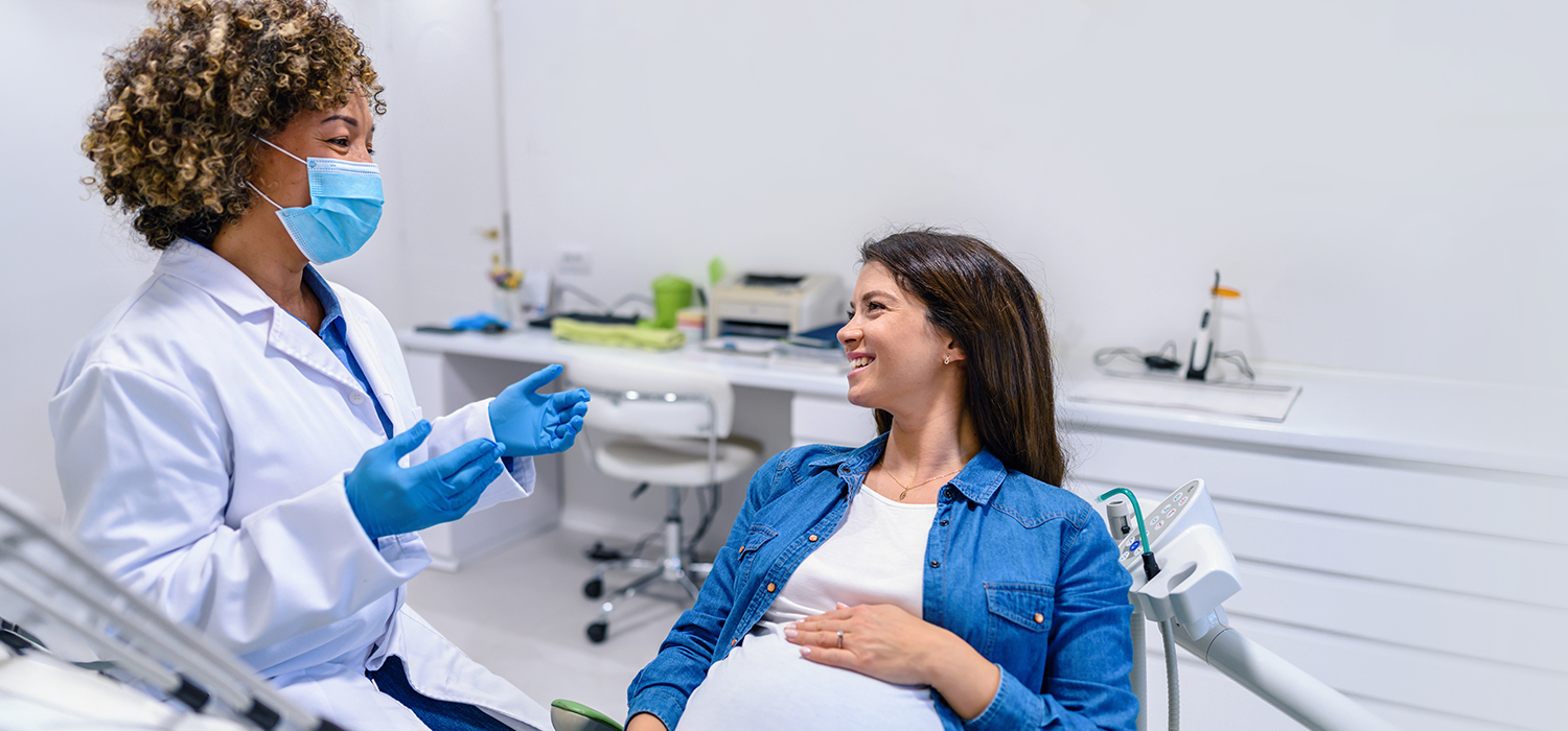 Dentist talking to a pregnant patient