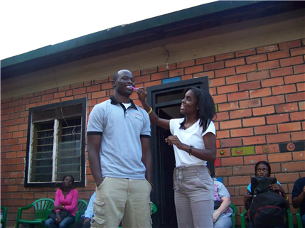 Oral health educator showing proper brushing