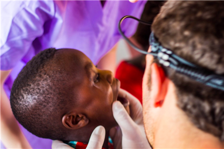 Dentist examining child