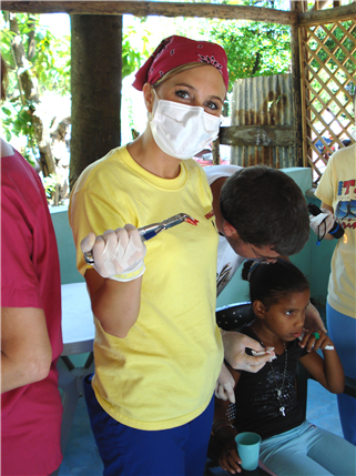 Dental volunteer holding extracted tooth