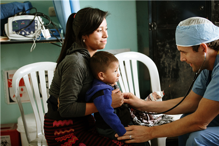 Doctor listening to baby