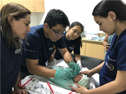 Doctor examining infant