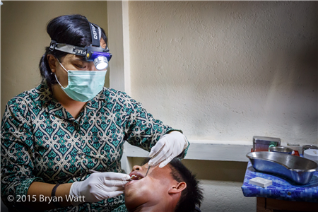 Dentist conducting exam