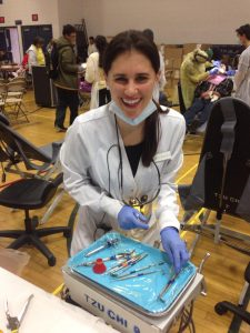 Dentist Smiling Holding tray of tools