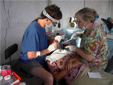 Dentist treating patient in overseas clinic