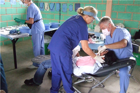 Dentist and assistant treating patient