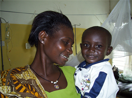 Photo of mother looking lovingly at her small child in a clinic